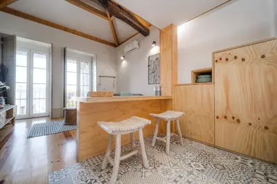 a kitchen with a counter and two stools at Nomad's Bonjardim City Flats in Porto