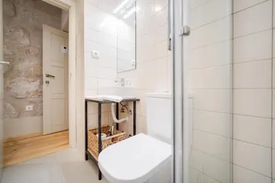 a bathroom with a toilet and a sink at Nomad's Bonjardim City Flats in Porto