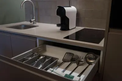 a kitchen drawer with utensils in it next to a sink at Olive Nature – Tourism Apartments in Porto