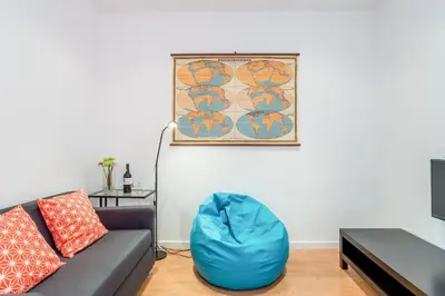 a living room with a couch and a blue bag on the floor at Alves da Veiga Apartments in Porto