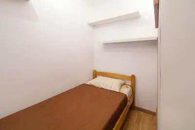 a small bedroom with a bed in a room at Studios Porto Solar in Porto