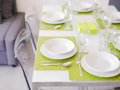 a table with white plates and glasses on it at CM VINTAGE Apartments - Breiner in Porto