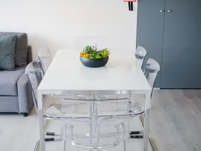 a white dining table with chairs and a plant on it at CM VINTAGE Apartments - Breiner in Porto