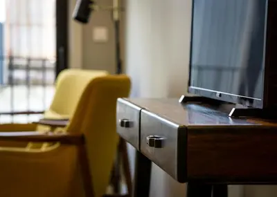 a desk with a tv on top of a wooden table at Porto Republica Apartments in Porto