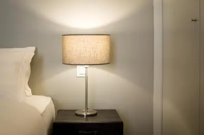 a lamp sitting on a table next to a bed at Porto Republica Apartments in Porto