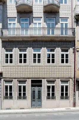 a building with a balcony on top of it at Get a Golden and Flower Flat in Porto