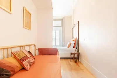 a room with a bed and a mirror in it at Get a Golden and Flower Flat in Porto