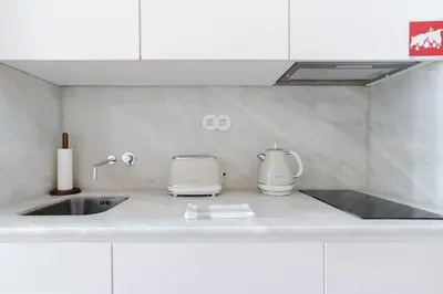 a kitchen counter with a sink and a mixer at Get a Golden and Flower Flat in Porto
