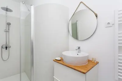 a bathroom with a sink and a mirror at Sancha Apartment - in the Centre near the Aliados in Porto