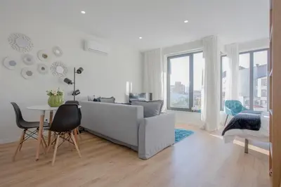 a white living room with a couch and a table at Liiiving in Porto I Bright Light Studio in Porto