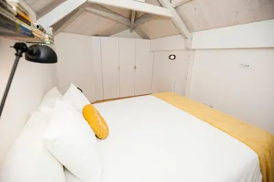 a bedroom with a bed with a corn on it at GET a Cactus and Books studio in Porto