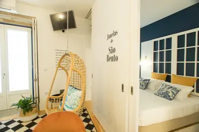 a room with a bed and a swing at Janelas de São Bento by Porto City Hosts in Porto