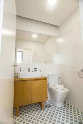 a white bathroom with a sink and a toilet at Janelas de São Bento by Porto City Hosts in Porto