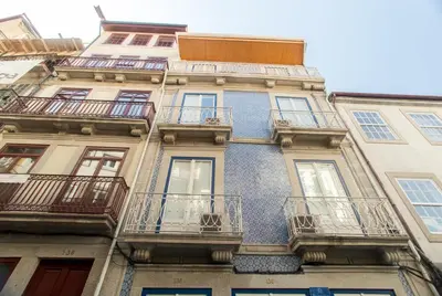 a tall building with balconies on the side of it at Janelas de São Bento by Porto City Hosts in Porto