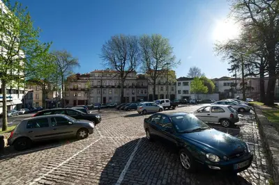a group of cars parked in a parking lot at Sunny view to the Tower in Porto