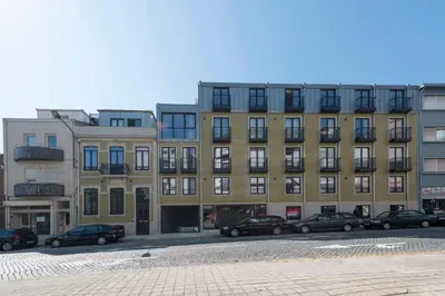 a large building with cars parked in front of it at LovelyStay - Downtown Balcony Apartment with Free Parking in Porto
