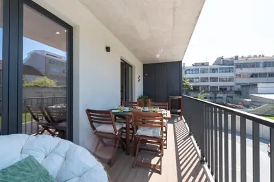 a balcony with a table and chairs on it at LovelyStay - Downtown Balcony Apartment with Free Parking in Porto