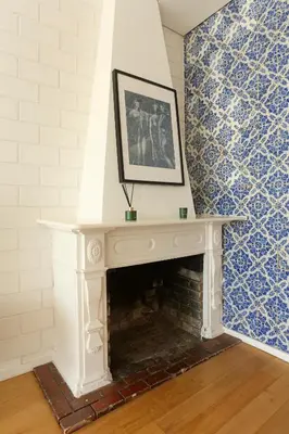 a white fireplace with a picture on top of it at Villa D'Ouro in Porto