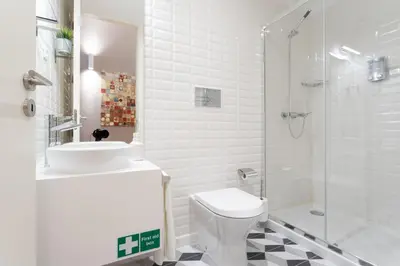 a bathroom with a sink and a toilet and a shower at Porto Garden Studio - Santa Catarina in Porto