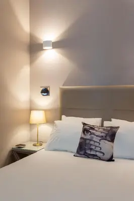 a bedroom with a white bed with a pillow on it at Porto Garden Studio - Santa Catarina in Porto