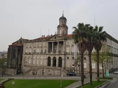 an old building with a clock tower on top of it at River Flat I - Heart of Porto in Porto
