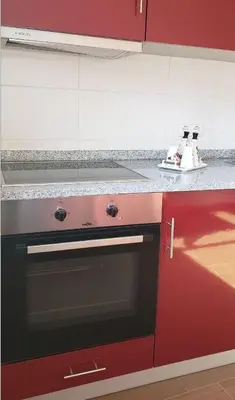 a kitchen with a red oven and a counter top at D'OURO DONA MARIA By LW in Vila Nova de Gaia