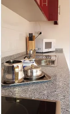 a kitchen counter with two pots and a sink at D'OURO DOM MANUEL By LW in Vila Nova de Gaia