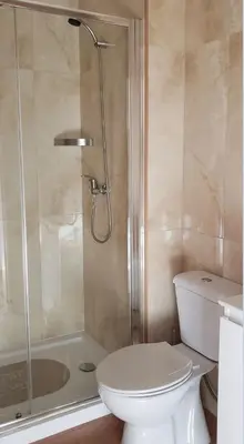 a bathroom with a white toilet and a shower at D'OURO DOM LUÍS By LW in Vila Nova de Gaia