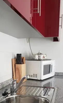 a kitchen counter with a microwave and a sink at D'OURO DOM LUÍS By LW in Vila Nova de Gaia
