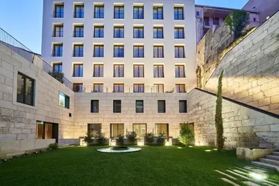 a large building with a lawn in front of it at PortoBay Flores in Porto