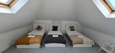 a attic room with three beds in it at Downtown Fantail in Porto