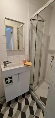 a bathroom with a sink and a shower at Downtown Fantail in Porto