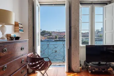 a living room with a view of the water at Porto Premium River View II in Porto