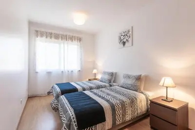 a bedroom with two beds and a window at Porto City Experience in Porto