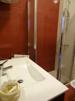 a bathroom with a sink and a shower at Porto City Experience in Porto