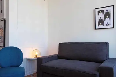 a living room with a couch and a chair at Panorama Apartments Ribeira Gaia in Vila Nova de Gaia