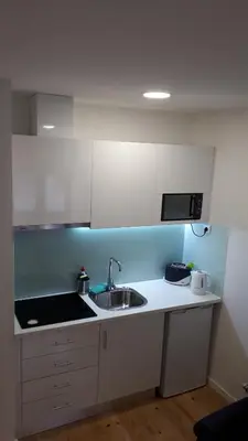 a kitchen with a sink and a microwave at TMB (Train / Metro& Bus ) Oporto Station House in Porto