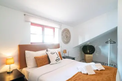 a bedroom with a large white bed with two towels on it at River Flat IV - Heart of Porto in Porto