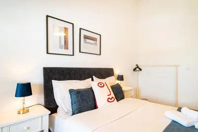 a bedroom with a large white bed and a window at River Flat IV - Heart of Porto in Porto