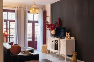 a living room with a tv on a white cabinet at River Flat IV - Heart of Porto in Porto