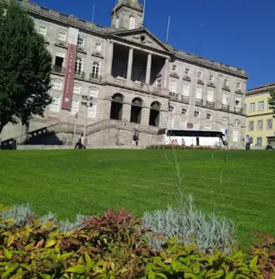 a large building with a green lawn in front of it at River Flat IV - Heart of Porto in Porto