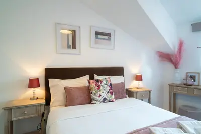 a bedroom with a bed with two night stands and two lamps at River Flat IV - Heart of Porto in Porto