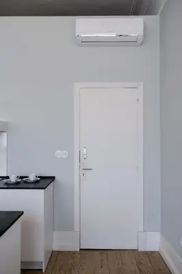 a white door in a white kitchen with a counter at Baixa24 •P2R• Bright Apt in Vibrant Downtown in Porto