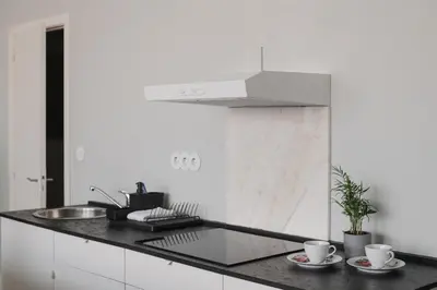 a kitchen with a counter with two cups and a sink at Baixa24 •P2R• Bright Apt in Vibrant Downtown in Porto