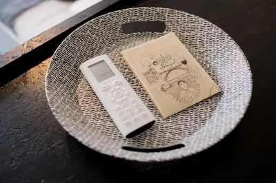 a remote control sitting on a plate on a table at Baixa24 •P2R• Bright Apt in Vibrant Downtown in Porto