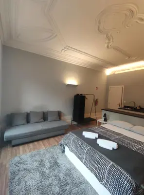 a living room with two beds and a couch at Baixa24 •P1R• Brand New Apt in the Historic Center in Porto