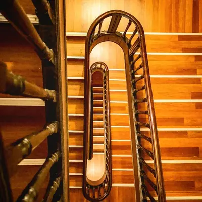 a spiral staircase in a room with wooden floors at Baixa24 •P1R• Brand New Apt in the Historic Center in Porto