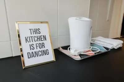 a sign sitting on a counter next to a blender at Baixa24 •P1L• Amplo estúdio na baixa com varanda in Porto