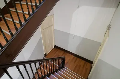 a staircase in a house with white walls and wooden floors at Baixa24 •P1L• Amplo estúdio na baixa com varanda in Porto