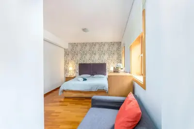 a bedroom with a bed and a couch at Cedofeita Paradise w parking included in Porto